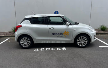 Silver hatchback vehicle featuring Access Uru Ātea branding, parked in a reserved "ACCESS" space, showcasing professional car signage for healthcare and community outreach.