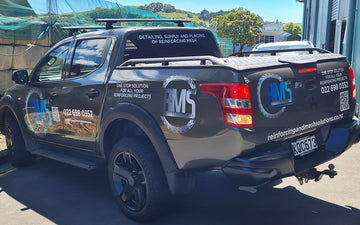 Rear and side view of RMS-branded ute displaying company logo, contact details, and vehicle signage for reinforcing mesh solutions in New Zealand.
