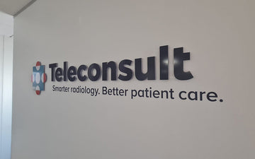 3D wall signage for Teleconsult with company logo and tagline ‘Smarter radiology. Better patient care.’ installed on interior office wall