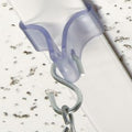 Close-up of clear ceiling grid clip in use, secured over metal ceiling grid for hanging lightweight signage or posters